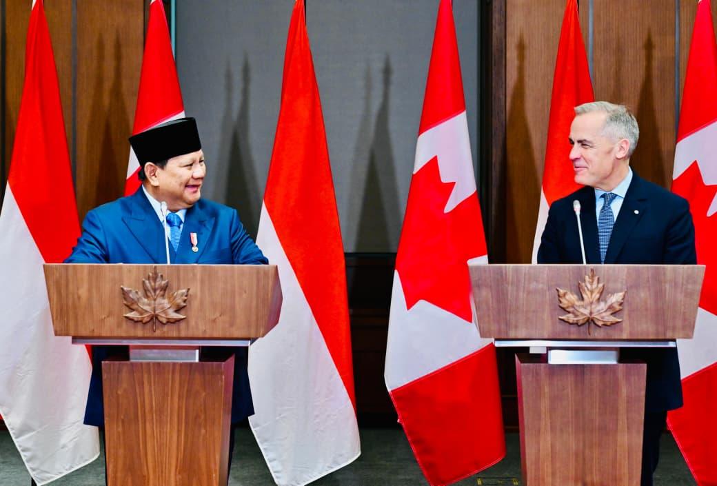 Prime Minister Mark Carney at a podium flanked by Canadian flags during a press conference in Ottawa